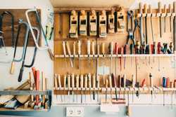 Assorted hand tools in a tool rack