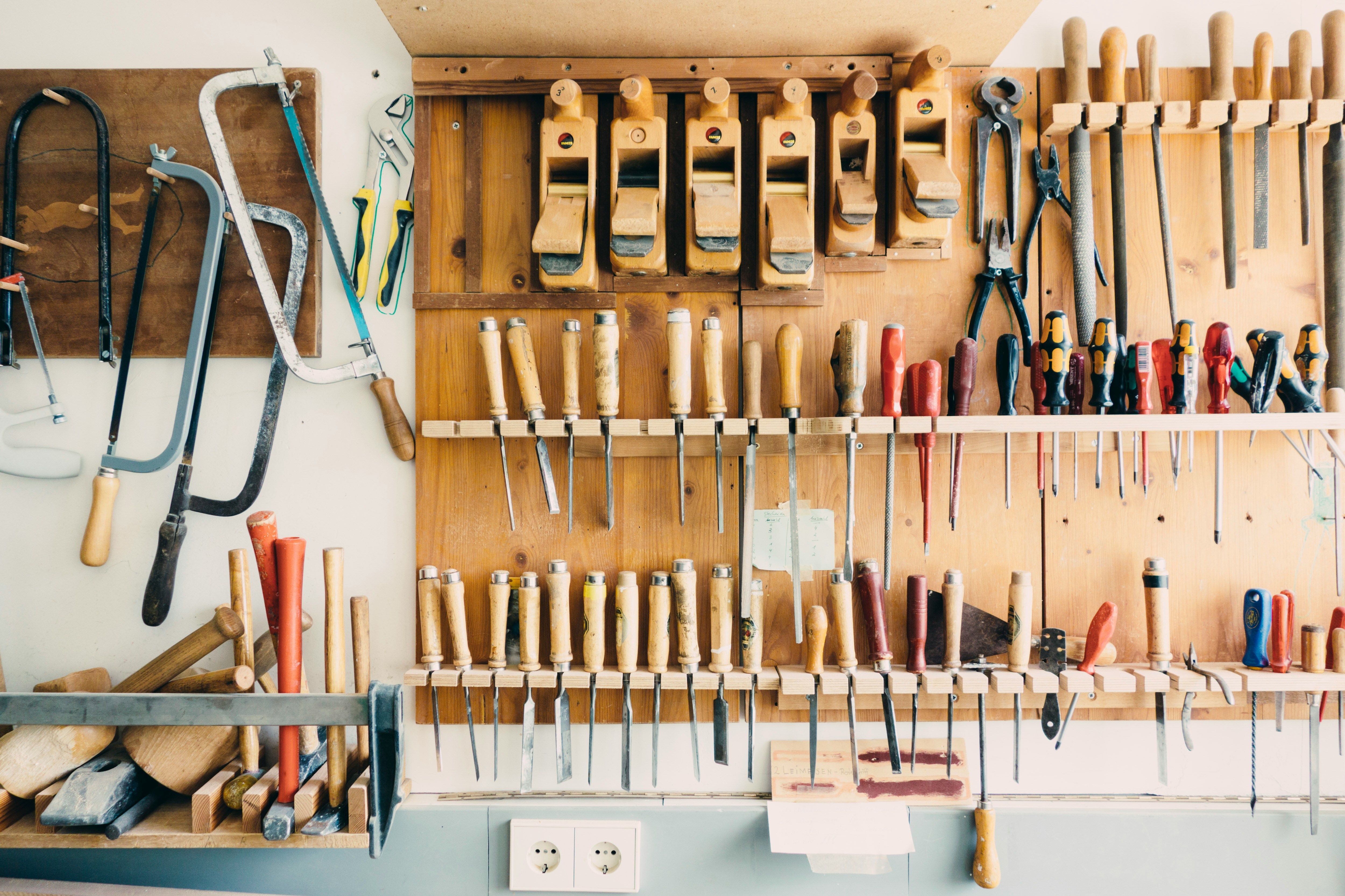 Assorted hand tools in a tool rack
